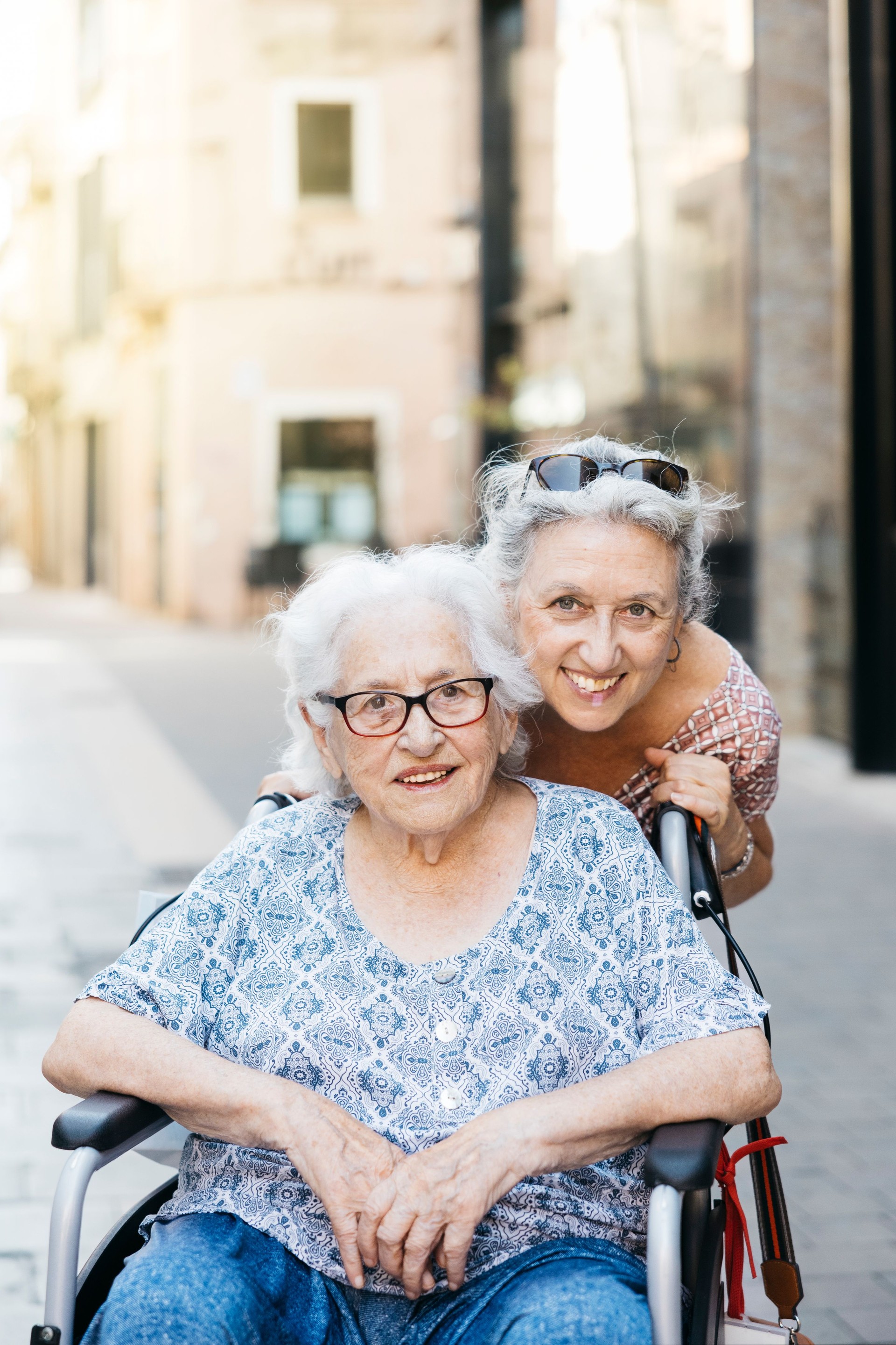 Senior daughter with her mother on street